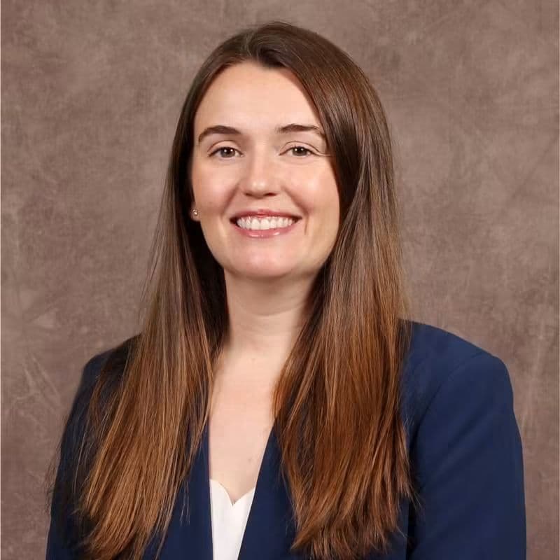 Mujer sonriente con cabello largo y lacio, vestida con un blazer, identificada como vicepresidenta de Bank of America.