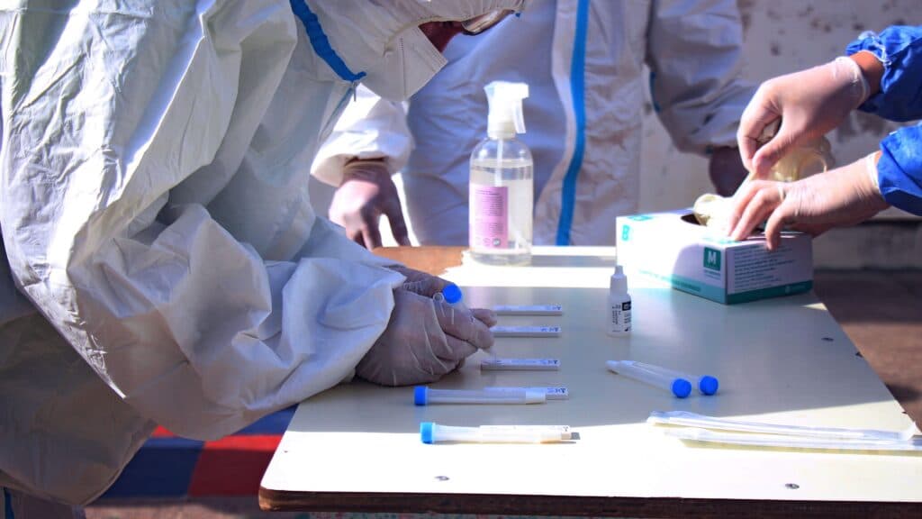 Investigadores en trajes de bioseguridad manipulan muestras en un laboratorio, en el contexto de estudios sobre la peste neumónica.